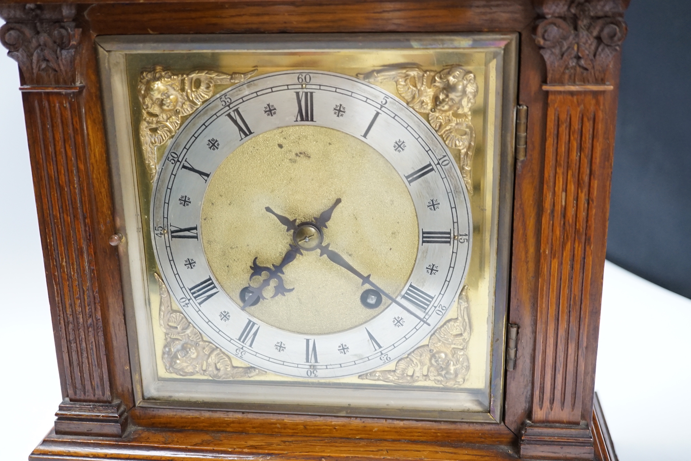 Victorian oak mantel clock, brass dial and mask spandrels; Winterhalder & Hoftmier two train movement, quarter striking in an architectural case, 39cm. (Provenance Phillips Chester 7/05/93), 40cm high